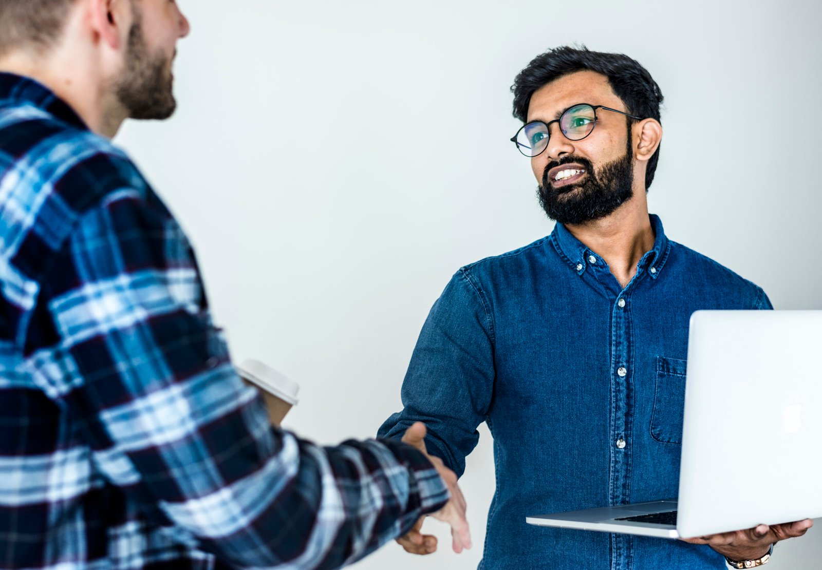 Diverse colleague men shaking hands together